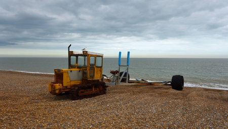 Caterpillar tractor on Aldeburgh beach used to haul fishing boats in and out of the seaのeditorial素材