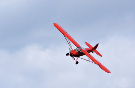 Vintage 1961 Piper Super Cub in flight close up.のeditorial素材