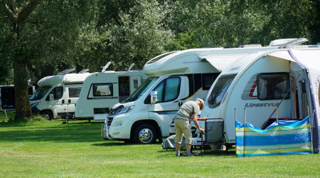 Camper  Vans on  Camp site among trees.のeditorial素材