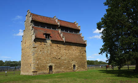Willington Dovecot on a sunny day blue sky and tree.の写真素材