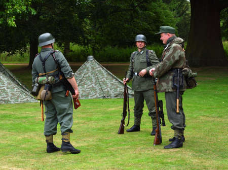 Three Infantryman from reenactment group in WW2  German uniforms with guns.のeditorial素材