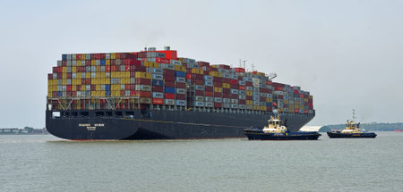 The container ship Maersk  Edirne  being turned by tug boats at the port of Felixstowe.