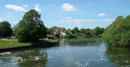 The river Ouse at Eaton Socon, St Neots Cambridgeshire water trees and old mill.