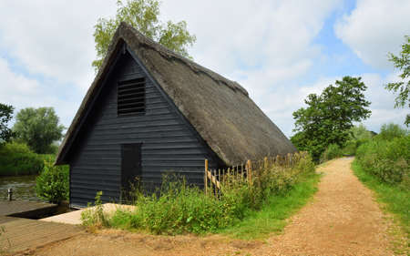 Boathouse and path by the river Ant in Norfolk Englandのeditorial素材