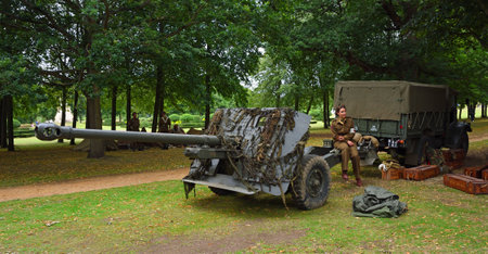 SILSOE, BEDFORDSHIRE, ENGLAND - AUGUST 14, 2021: World War 2 Field gun and Truck with girl in uniform.のeditorial素材