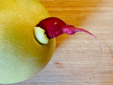 Fresh ripe pomelo fruit on a wooden cutting board close-up