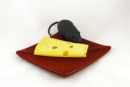 Cheese and a mouse on a plateの写真素材