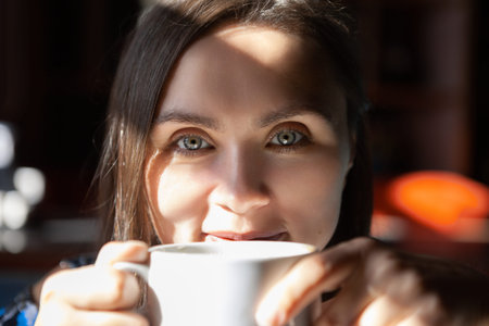 beautiful woman is drinking coffee in the morning at cafe.