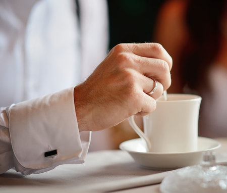 Man's hand with a cup of tea