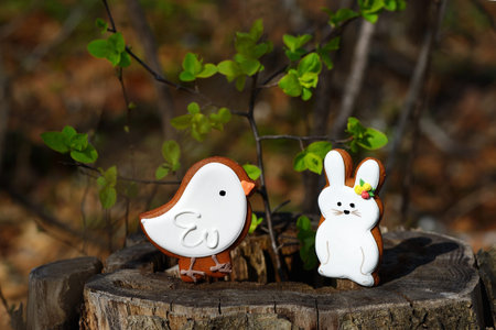 Gingerbread  bird and rabbit in a forest on a stump