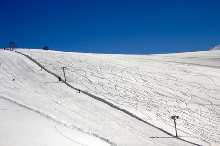 Skiing facility and the traces on ground.there are wires in order to carry people to top of the hill