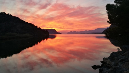 Wonderful hill reflection and sunset over lake.の写真素材