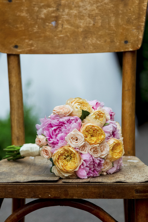 Beautiful wedding bouquet on a wooden shabby chair.の写真素材