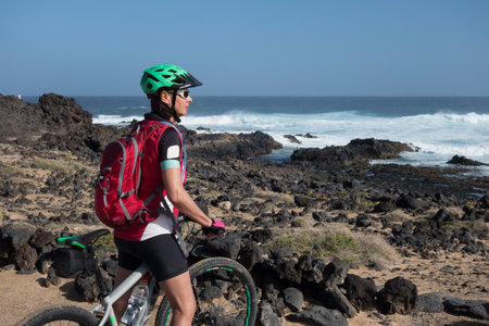 Senior man mountainbiking on volcanic trails of Lanzarote Island, Canary Islands, Spain