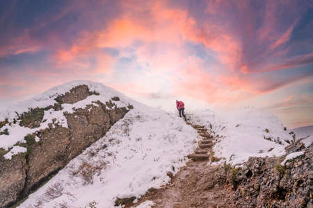 Active woman hiking in the first autumnal snow in the Allgau Alps near Oberstaufen, Bavaria, Germanyの写真素材