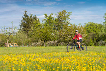 adult, agriculture, agriculture field, alone, background, basket, beautiful, beauty, bicycle, bike, biking, blossoms, caucasian, countryside, cycle, e-bike, ebike, electric bicycle, female, field, floの写真素材