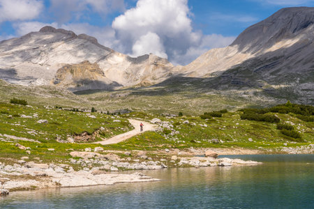 nice active senior woman riding her electric mountain bike in the Fanes high Valley, part of Fanes-Sennes-Braies nature park in the Alta Badia Dolomites, South Tirol and Trentino, Italyの写真素材