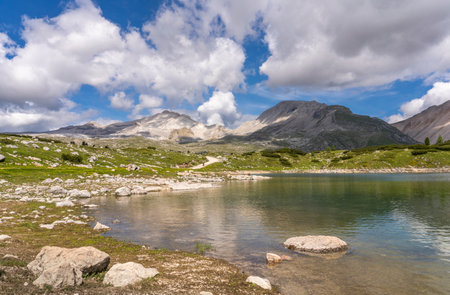 nice active senior woman riding her electric mountain bike in the Fanes high Valley, part of Fanes-Sennes-Braies nature park in the Alta Badia Dolomites, South Tirol and Trentino, Italyの写真素材