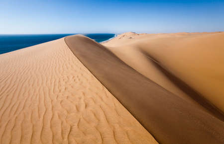 Sand dunes in The Namib desert along side the atlantic ocean coast, southern Africa, Namibiaの写真素材