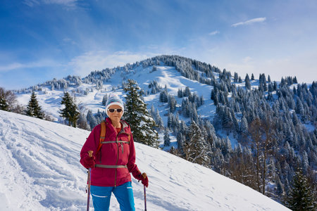 Woman on the top of the mountain in winterの写真素材