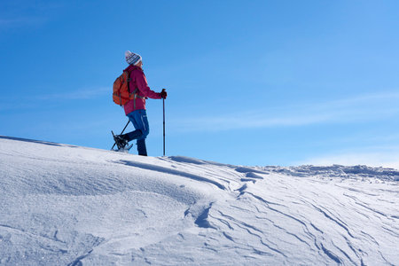 Winter hiking in the mountains on snowshoes with a backpack and tent.の写真素材