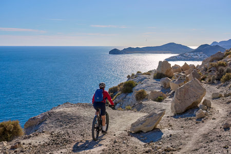 Cyclist Riding the Mountain Bike on the Rocky Coast of the Island of Rhodes in Greece.の写真素材