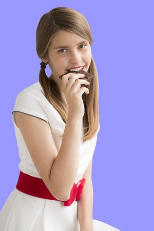 Portrait of young beautiful  teenage girl with chocolateの写真素材