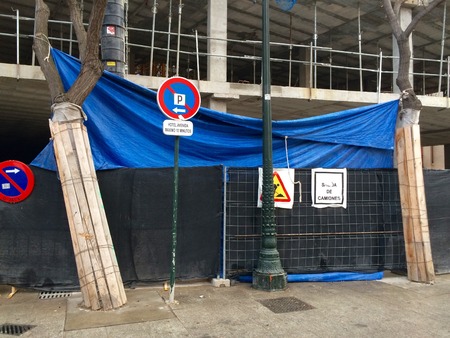 Skeleton phase with columns and cement floors, with formwork, plastic protector, blue and black mesh, black plastic tube, hopper or metal structure as a debris descent system.の写真素材