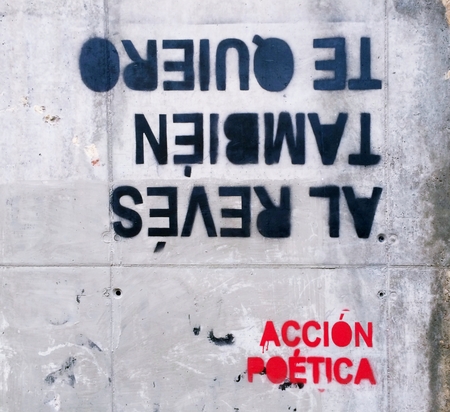 Artistic current of poets and thinkers who write with curious spray poetically correct phrases, philosophical or amorous tone, in urban walls of cities. I love you also upside down.の写真素材