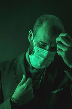 A young Caucasian man concerned about the coronavirus pandemic, Covid-19の写真素材