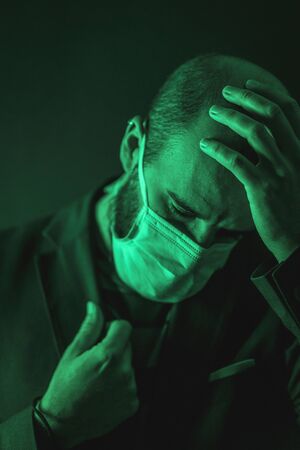 A young Caucasian man after sad news in the coronavirus pandemic, Covid-19の写真素材
