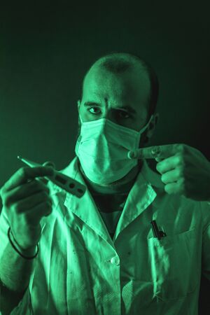 A doctor measuring the temperature of fever in the coronavirus pandemic, Covid-19の写真素材