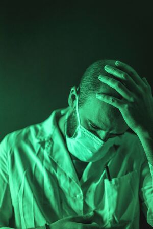 A doctor working under a lot of pressure in the coronavirus pandemic, Covid-19の写真素材