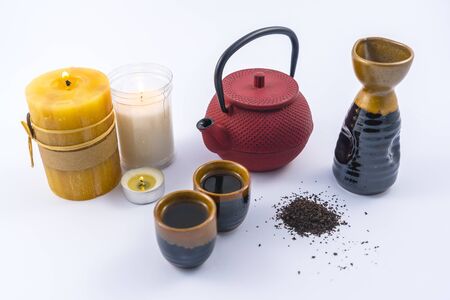 Japanese tea with candles and a cup and Japanese glassesの写真素材
