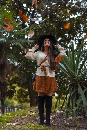 A young brunette in a photo shoot in autumnの写真素材