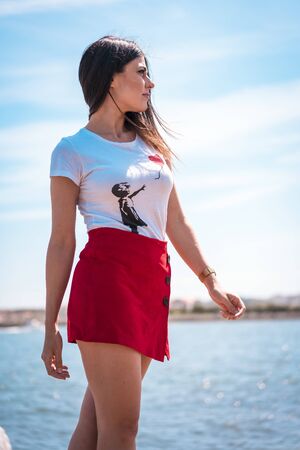 Street style, portrait of a pretty brunette in a white shirt looking to the leftの写真素材