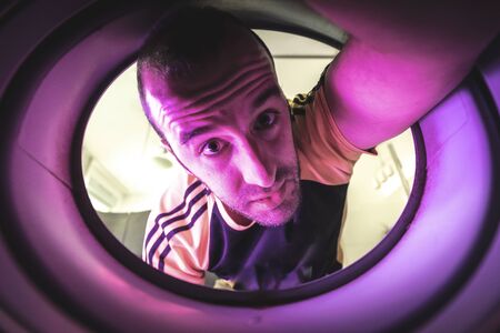 Am I escaping from quarantine through this hole? Photo inside a washing machineの写真素材