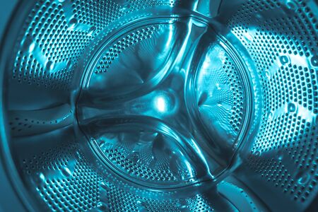 Interior of a cyan light photographed washing machine in a houseの写真素材