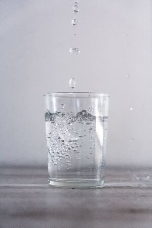 Large drops of water in a glass of water. Drink macro photographyの写真素材