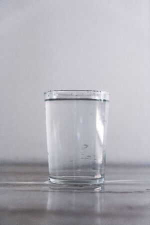A glass of water on a white background. Drink macro photographyの写真素材