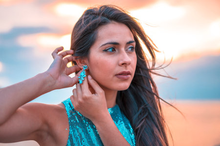 Street style, A pretty brunette in a beautiful sunset in a tight sequin dress