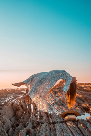 Lifestyle, a levitating woman in a white dress with black dots on a sunset