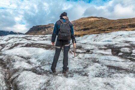 A young tourist on the ice of the Svinafellsjokull glacier. Icelandの写真素材