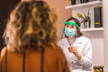 Beauty Salon, reopening after the coronavirus pandemic with security measures. Female doctor with...