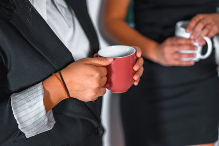 Session young entrepreneurs in the office, 2 young Caucasian women having tea in the office on the...