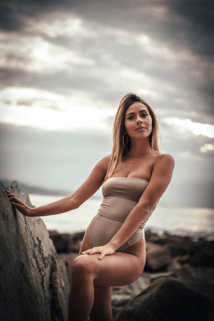 Portrait of caucasica with a brown swimsuit in a natural setting on the coast of Zumaia, Gipuzkoa....