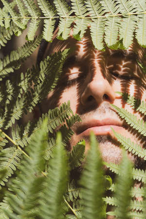 A young man inside nature ferns. Listorreta Natural Park in the town of Errenteria in the PeÃ±as de Aya or Aiako Harria park. Gipuzkoa, Basque Countryの写真素材
