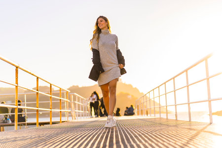 Lifestyle, a blonde on the coast at sunset. Strolling along the promenade enjoying the beautiful...