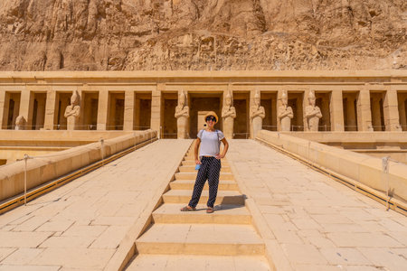 A young woman on the entrance stairs to the Funerary Temple of Hatshepsut in Luxor. Egypt