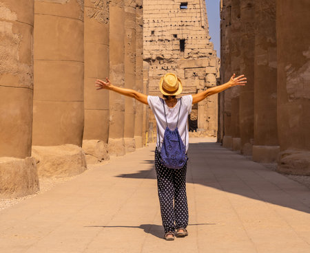 A young tourist wearing a hat visiting the Egyptian Temple of Luxor. Egypt